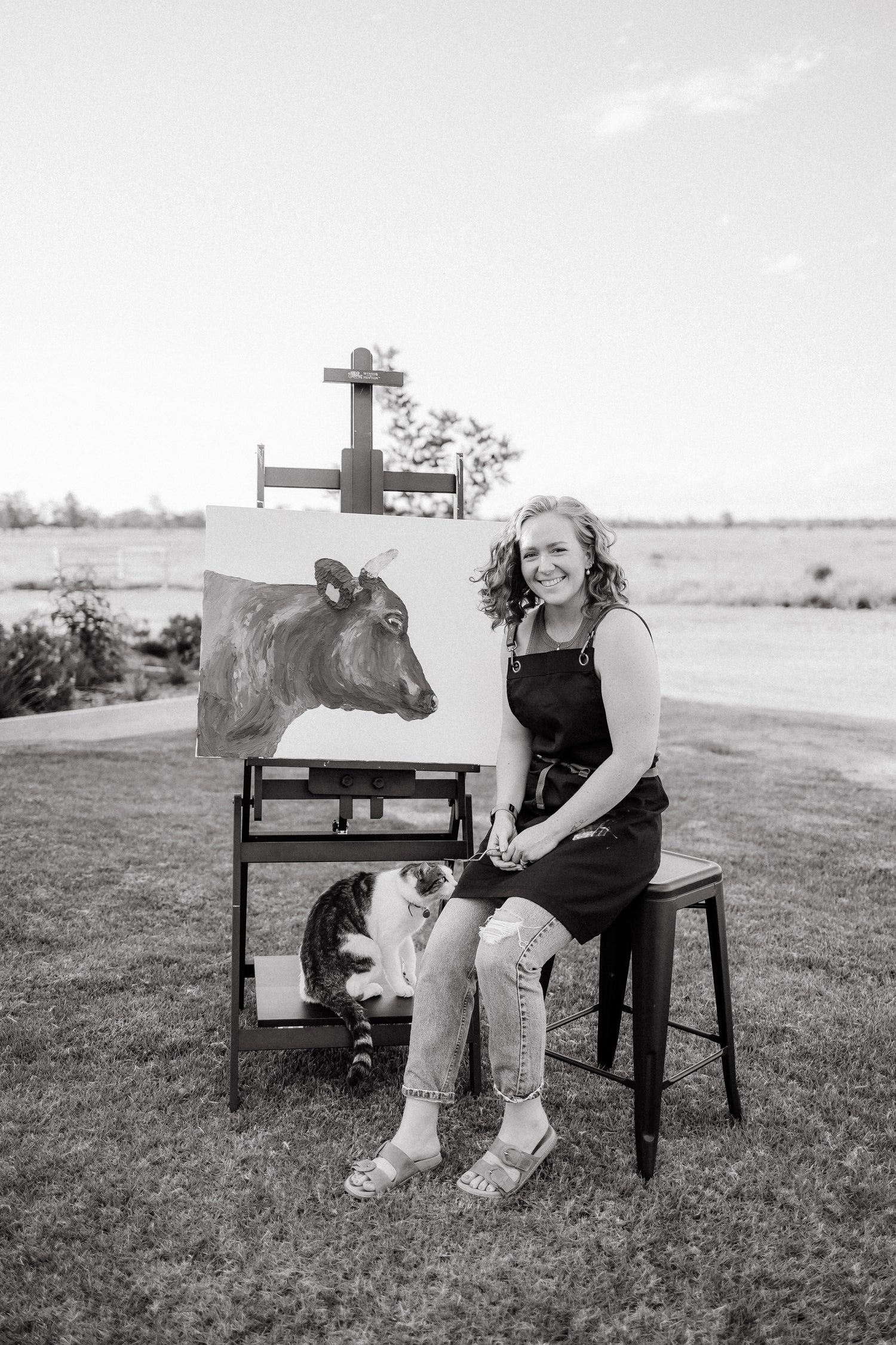 Julia Proud-Maher with Matilda artwork on easel in black and white